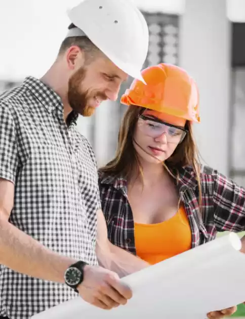 two people reviewing construction plans
