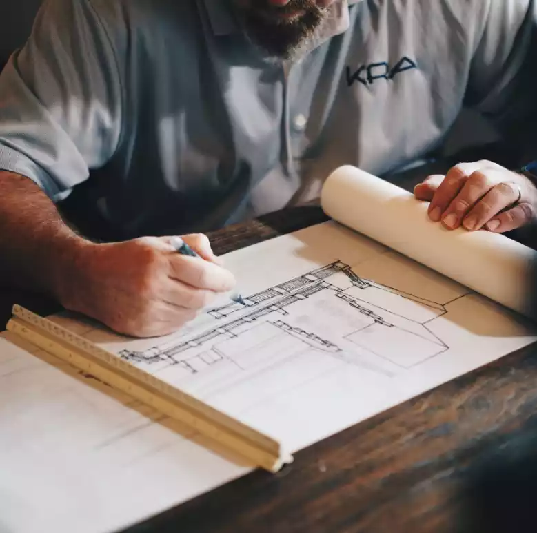 person drawing a blueprint