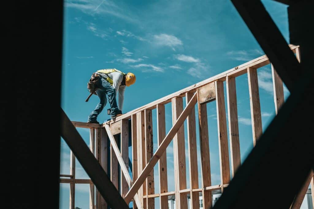 construction worker installing frames for a new build